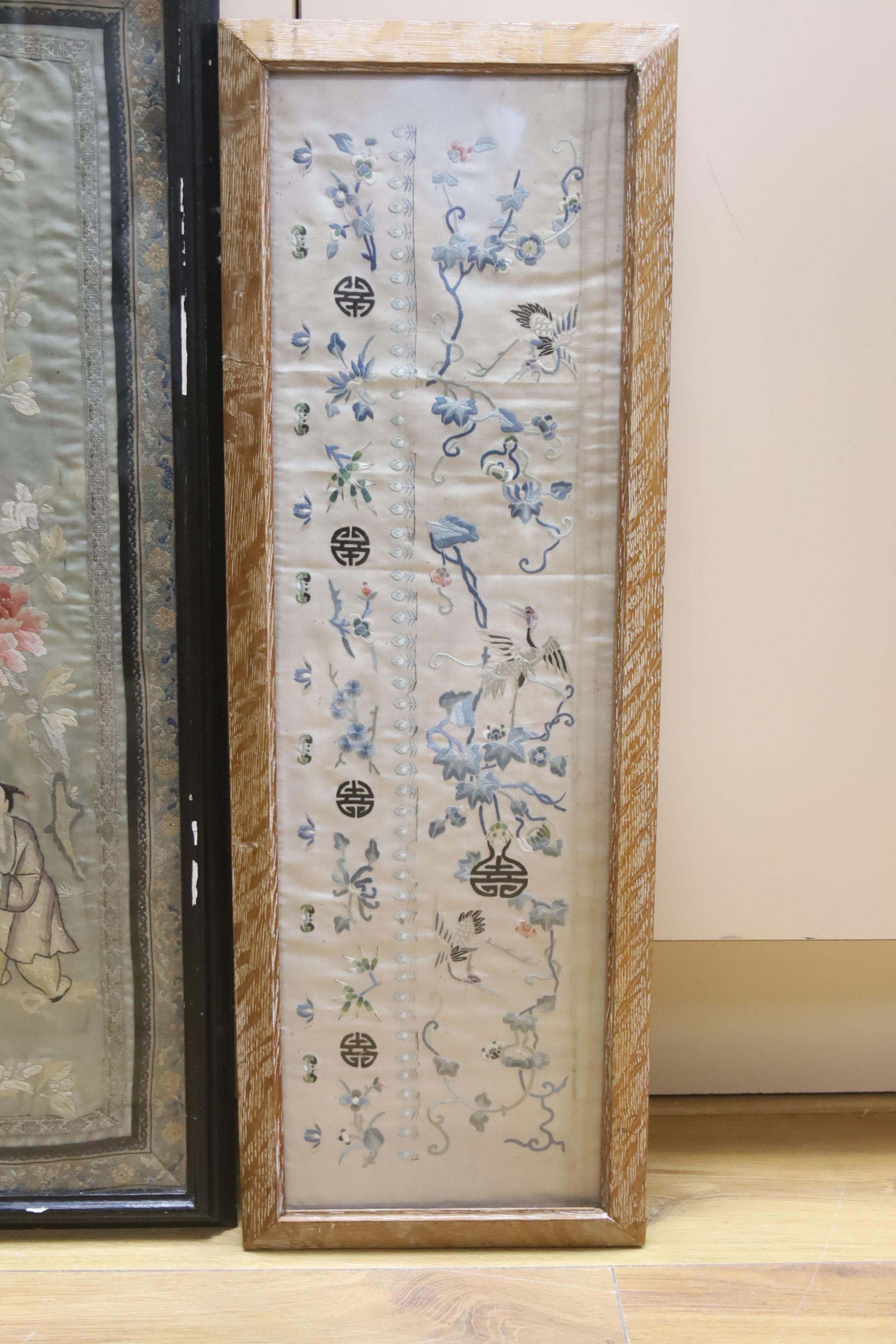 A Chinese embroidered sleeve band and a pair of embroidered sleeve bands (in one frame), largest 64 x 28cm